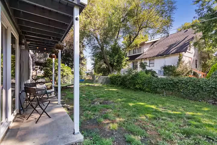 Covered outdoor sitting area overlooking the yard