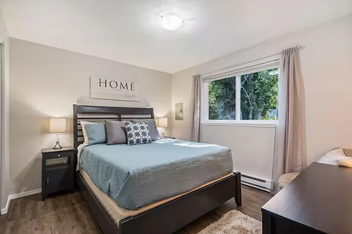 Bedroom with blue bedding and window