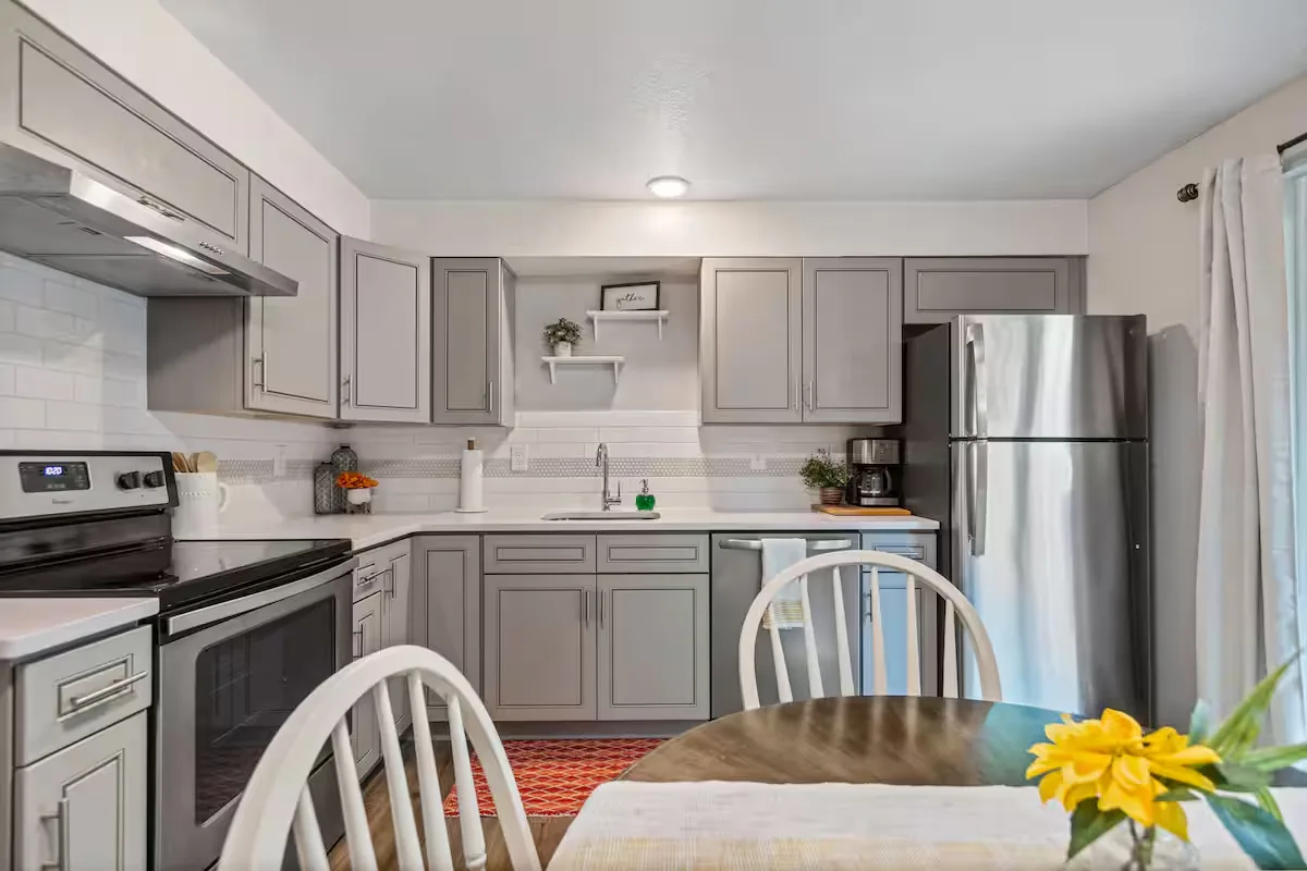 Full kitchen with gray cabinets and stainless appliances