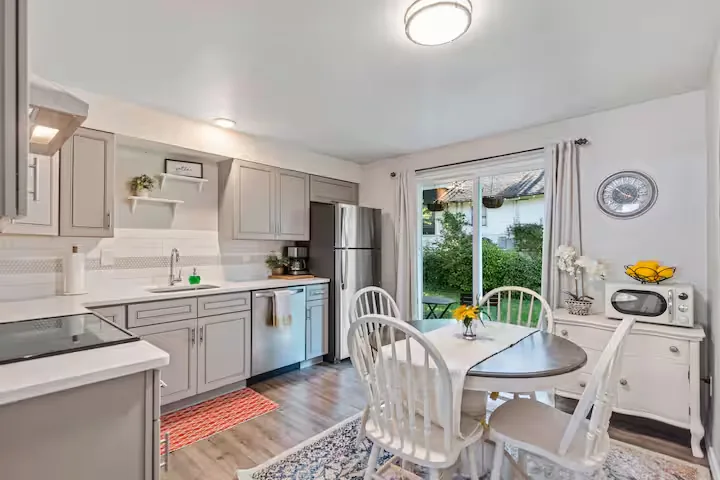 Kitchen with stove, refrigerator, and breakfast table